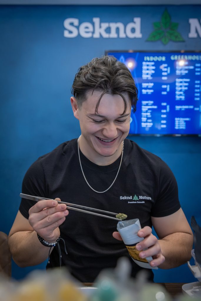 The owner of Seknd Nature in Linksfield Johannesburg uses a tweezer to select a premium cannabis bud